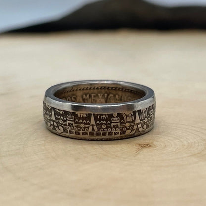 Mexico 10 Centavos Coin Ring on a light wood round with mountain outline in the background. - Mountainstruck Coin Jewelry