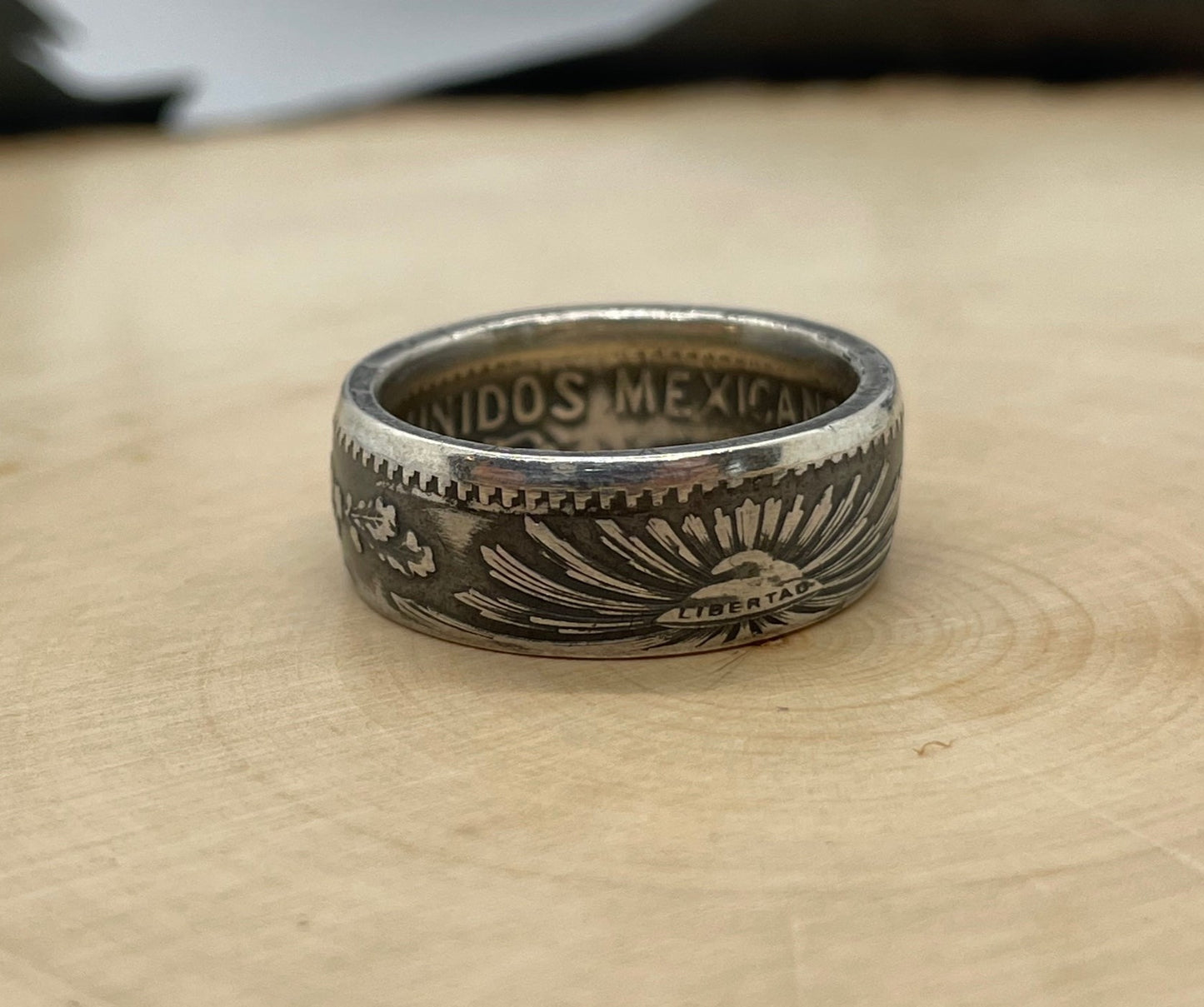 Mexico 50 Centavos Silver Coin Ring (Rare) on a light wood round. - Mountainstruck Coin Jewelry