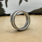 Mexico 50 Centavos Silver Coin Ring (Rare) on its edge on a light wood round with mountain outline in the background. - Mountainstruck Coin Jewelry