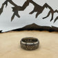 Mexico Silver Peso Coin Ring on a light wood round with mountain outline in the background. - Mountainstruck Coin Jewelry
