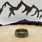 Mexico Silver Peso Coin Ring on a light wood round with mountain outline in the background. - Mountainstruck Coin Jewelry