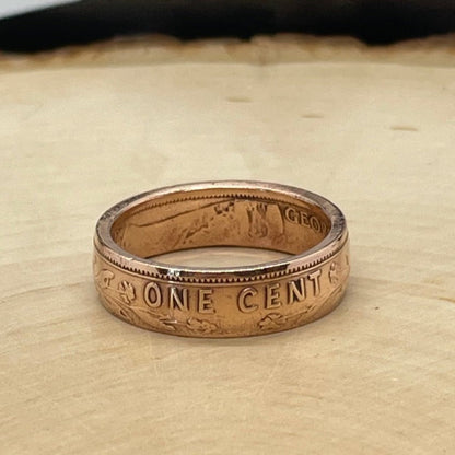 Newfoundland 1 Cent Coin Ring on a light wood round. - Mountainstruck Coin Jewelry