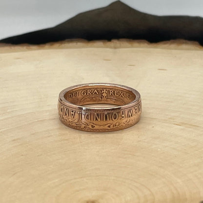 Newfoundland 1 Cent Coin Ring on a light wood round. - Mountainstruck Coin Jewelry