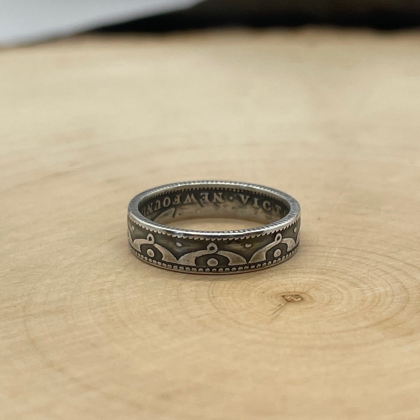 Newfoundland 10 Cents Silver Coin Ring on a light wood round. - Mountainstruck Coin Jewelry
