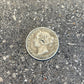 Newfoundland 10 Cents Silver Coin front on a concrete surface. - Mountainstruck Coin Jewelry