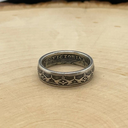 Newfoundland 20 Cents Silver Coin Ring on a light wood round. - Mountainstruck Coin Jewelry