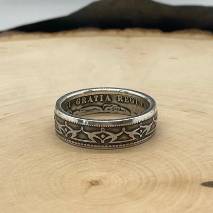 Newfoundland Early 50 Cents Silver Coin Ring on a light wood round.  - Mountainstruck Coin Jewelry