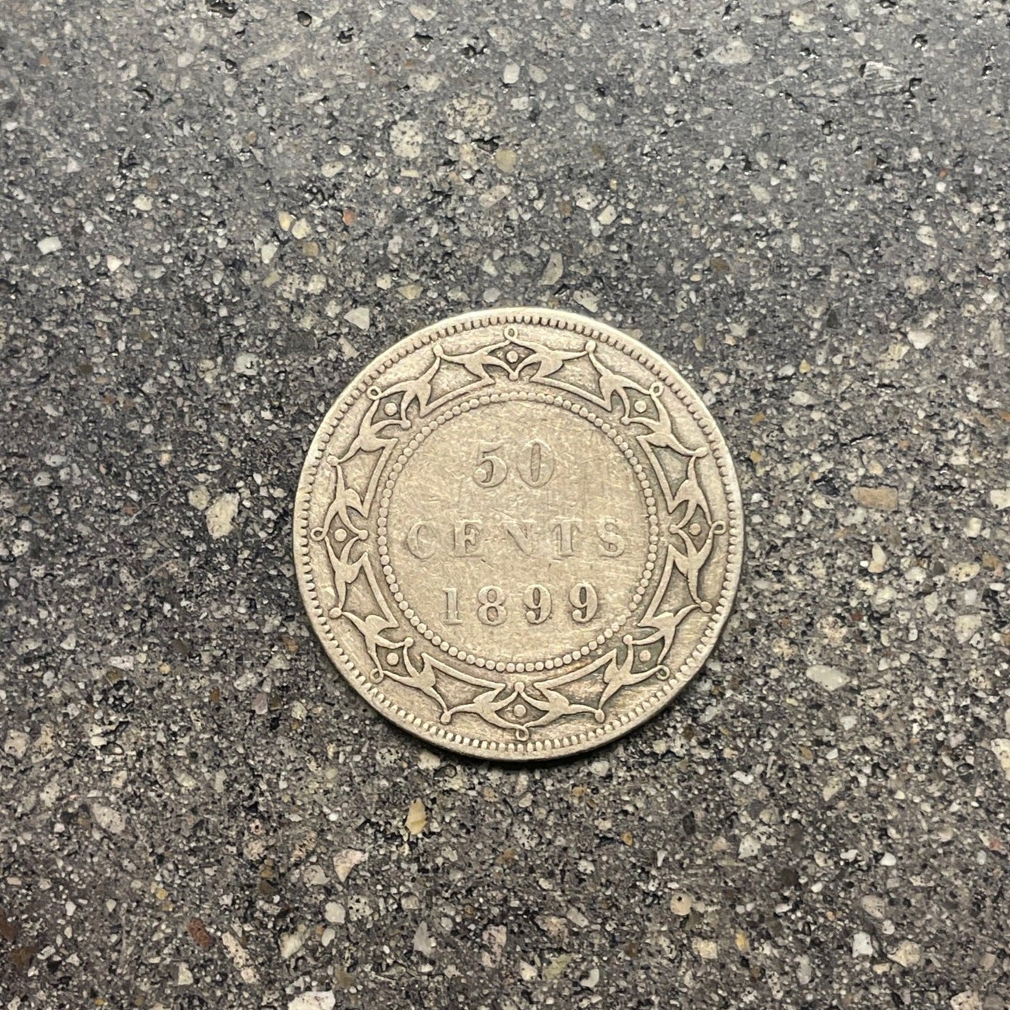 Newfoundland Early 50 Cents Silver Coin back on concrete background. - Mountainstruck Coin Jewelry