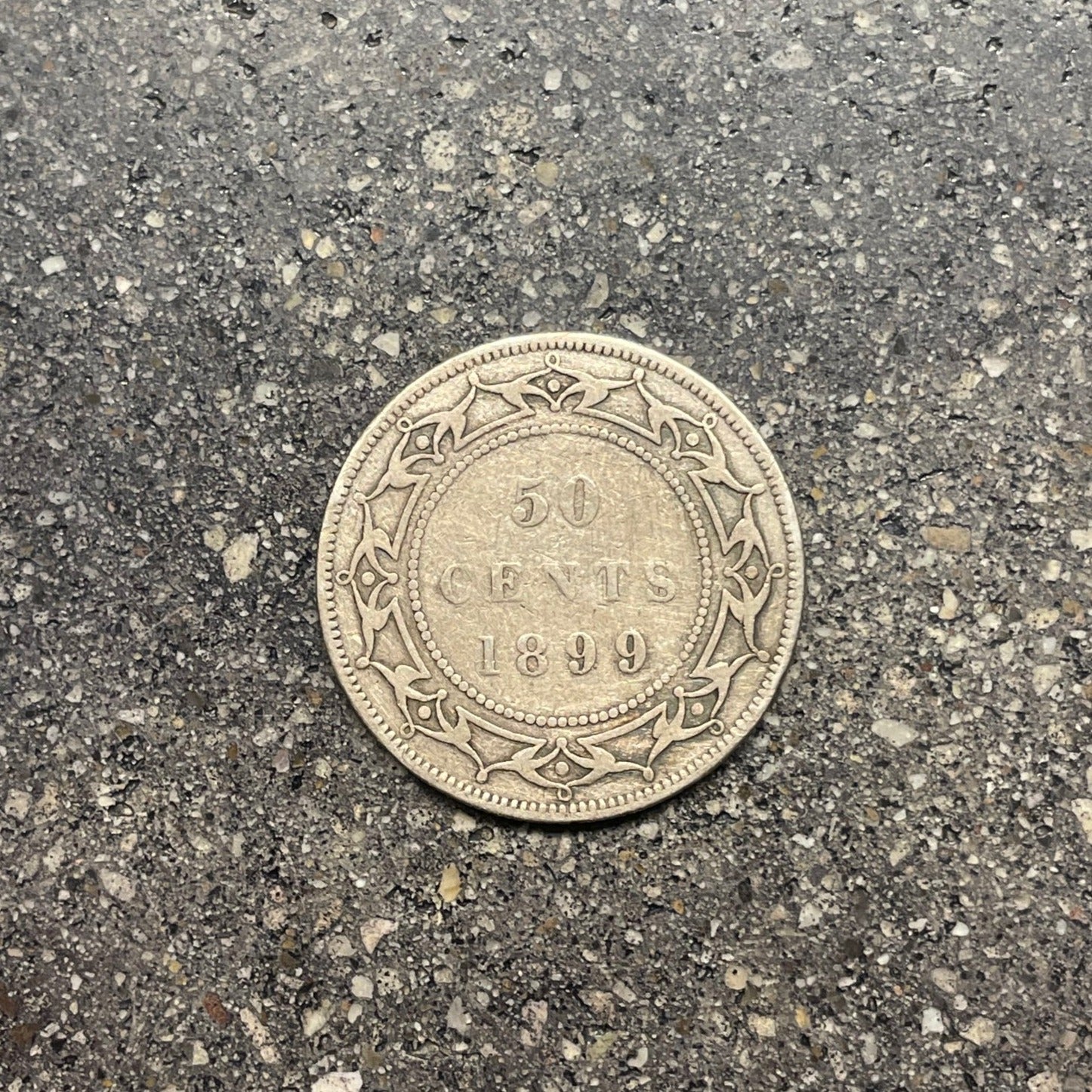 Newfoundland Early 50 Cents Silver Coin back on concrete background. - Mountainstruck Coin Jewelry