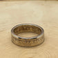 Presidential Gold Dollar Coin Ring on light wood round.