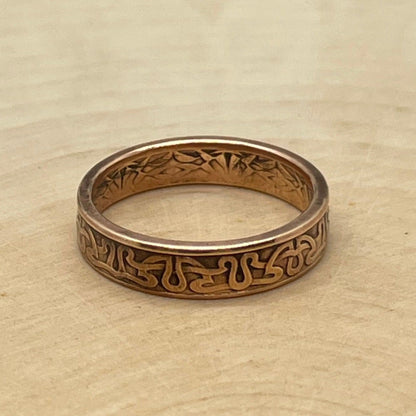 Suriname 1 Cent Coin Ring on a light wood round. - Mountainstruck Coin Jewelry