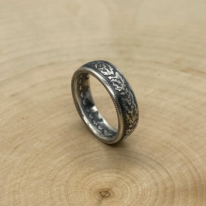 Swiss 1/2 Franc Silver Coin Ring on its side on a light wood round. - Mountainstruck Coin Jewelry