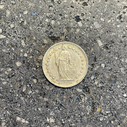 Swiss 1/2 Franc Silver Coin front on a concrete background. - Mountainstruck Coin Jewelry