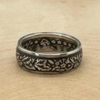 Swiss 1 Franc Silver Coin Ring on a light wood round with mountain outline in background. - Mountainstruck Coin Jewelry
