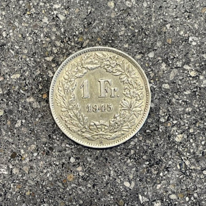 Swiss 1 Franc Silver Coin back on a concrete background. - Mountainstruck Coin Jewelry
