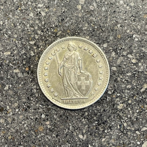 Swiss 1 Franc Silver Coin front on a concrete background. - Mountainstruck Coin Jewelry