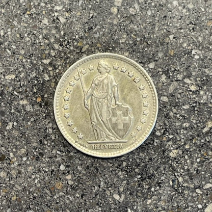 Swiss 1 Franc Silver Coin front on a concrete background. - Mountainstruck Coin Jewelry