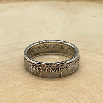 UK One Shilling Silver Coin Ring (shine) on a light wood round. - Mountainstruck Coin Jewelry