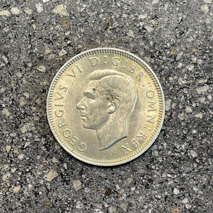 UK One Shilling Silver Coin front on a concrete background.  - Mountainstruck Coin Jewelry