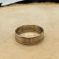 Sacagawea Dollar Coin Ring on a light wood round with mountain outline in background. - Mountainstruck Coin Jewelry
