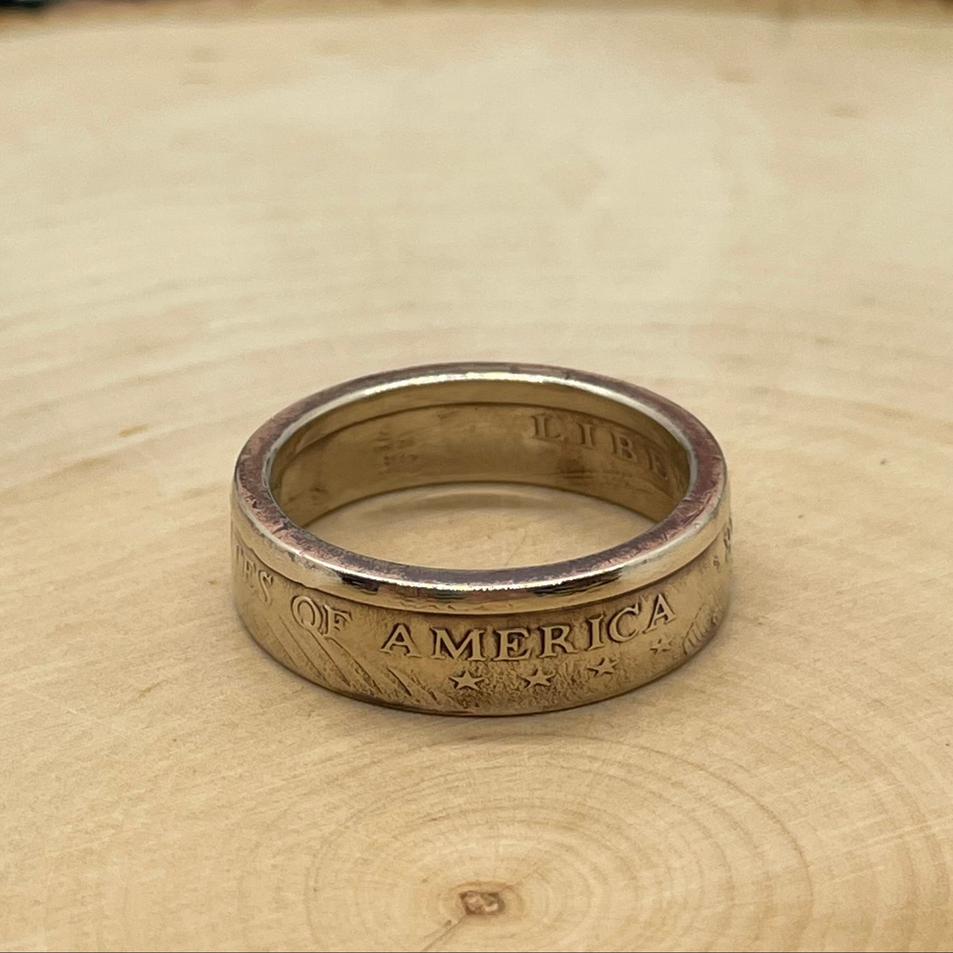 Sacagawea Dollar Coin Ring on a light wood round. - Mountainstruck Coin Jewelry