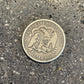Seated Liberty Silver Half Dollar Coin back on a concrete background. - Mountainstruck Coin Jewelry