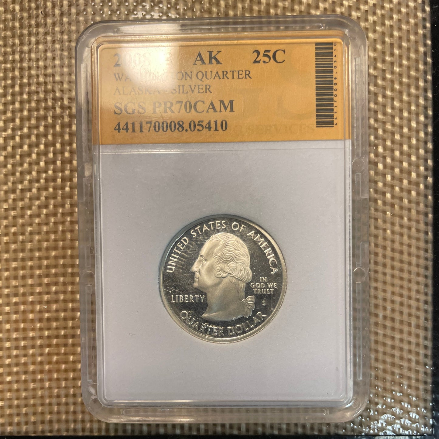 U.S. State Quarter Silver Coin front in plastic verification case on a woven background. - Mountainstruck Coin Jewelry