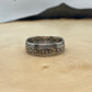 U.S. Barber Silver Quarter Coin Ring (front) on a light wood round with mountain outline in the background. - Mountainstruck Coin Jewelry