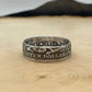 U.S. Barber Silver Quarter Coin Ring (reverse) on a wood round with mountain outline in the background. - Mountainstruck Coin Jewelry