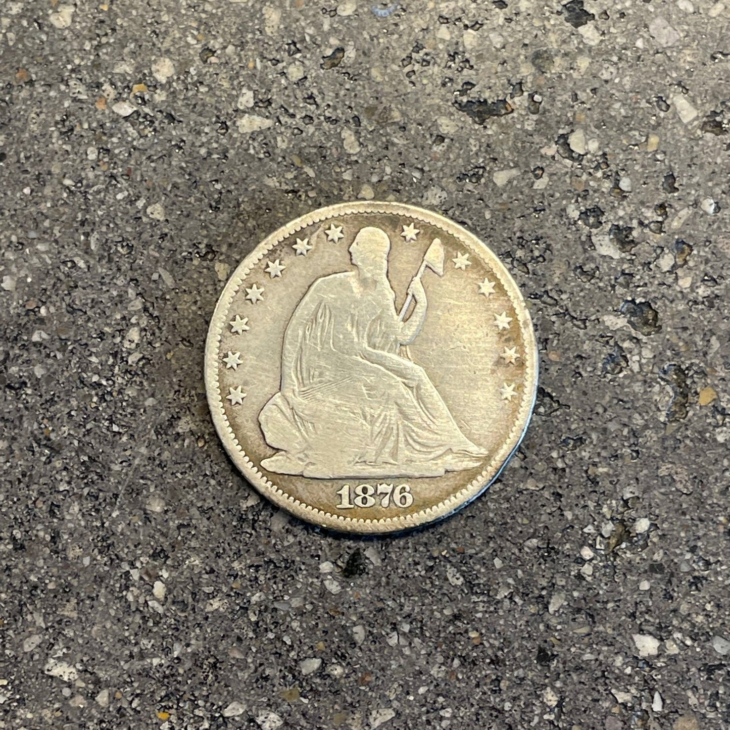 U.S. Seated Liberty Silver Half Dollar Coin front on a concrete background. - Mountainstruck Coin Jewelry