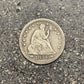 U.S. Seated Liberty Silver Quarter Coin front on a concrete background. - Mountainstruck Coin Jewelry