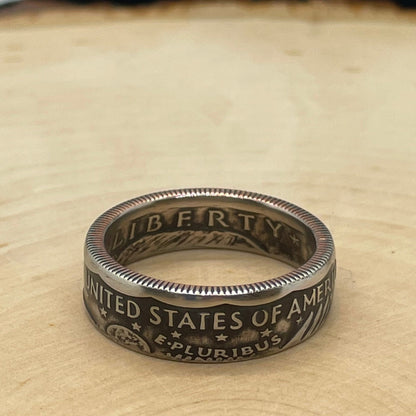 U.S. Susan B. Anthony Dollar Coin Ring on a light wood round. - Mountainstruck Coin Jewelry