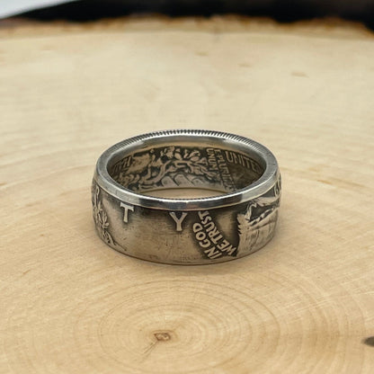 U.S. Walking Liberty Half Dollar Silver Coin Ring on a light wood round. - Mountainstruck Coin Jewelry