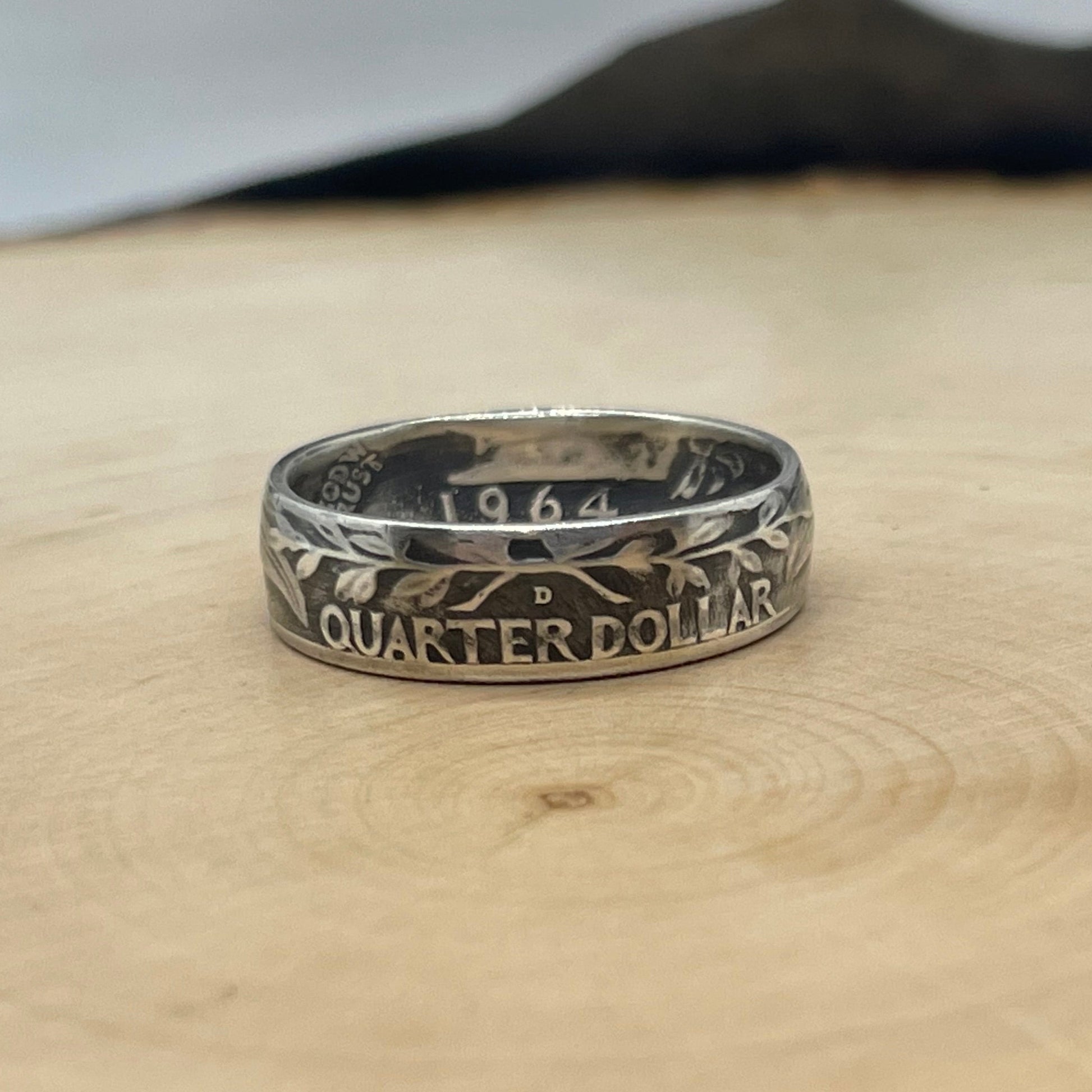 U.S. Washington Silver Quarter Coin Ring (reverse) on a light wood round. - Mountainstruck Coin Jewelry