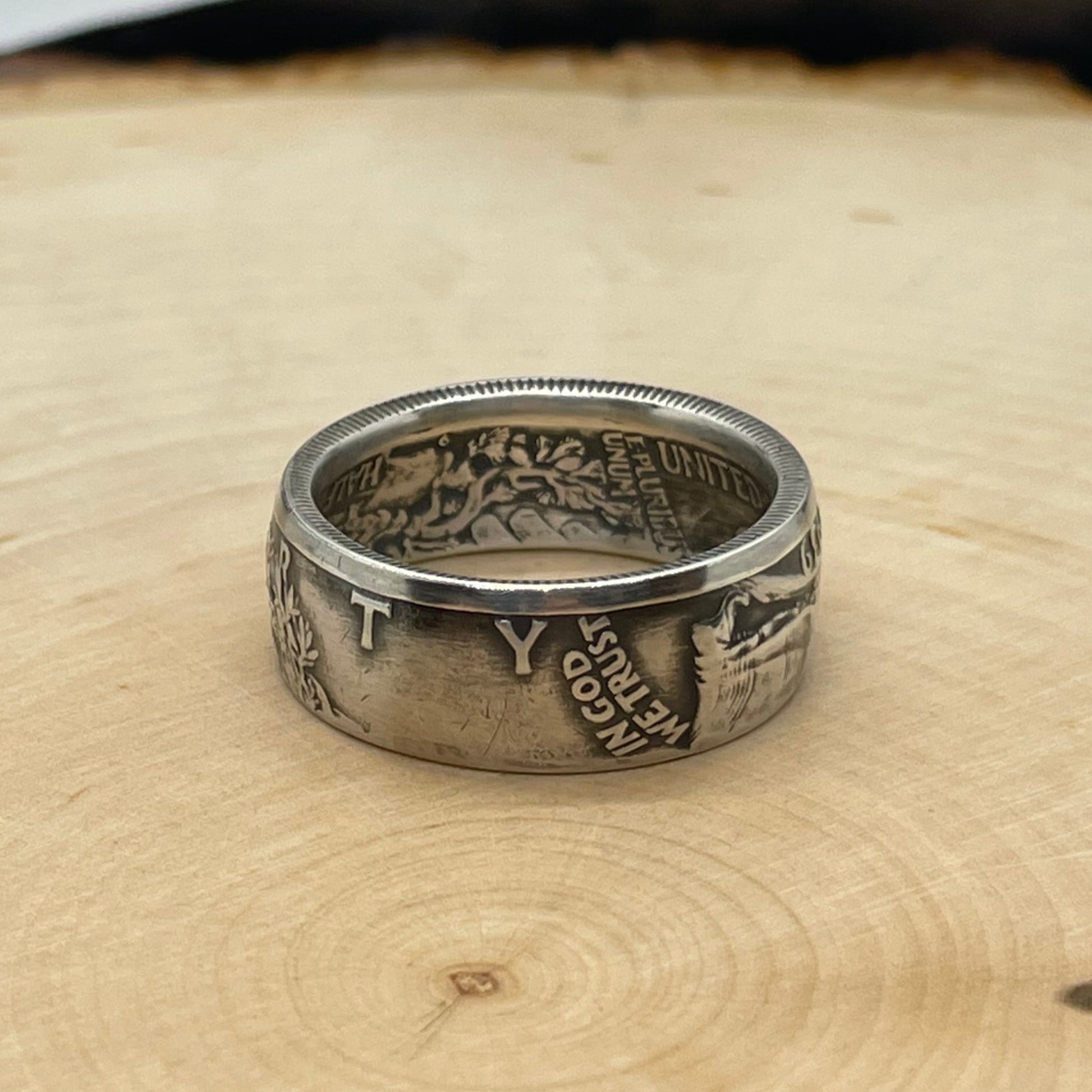 Walking Liberty Half Dollar Silver Coin Ring on a light wood round. - Mountainstruck Coin Jewelry