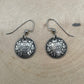 Canada 10 Cents Silver Domed Earrings on a light wood round.