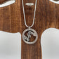U.S. Saratoga British Surrender Hand Cut Coin Necklace on wood tree display.