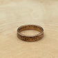 Suriname 1 Cent Coin Ring on a light wood round.