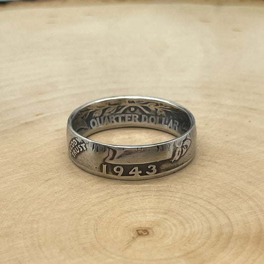 Washington Silver Quarter Coin Ring (front) on a light wood round.