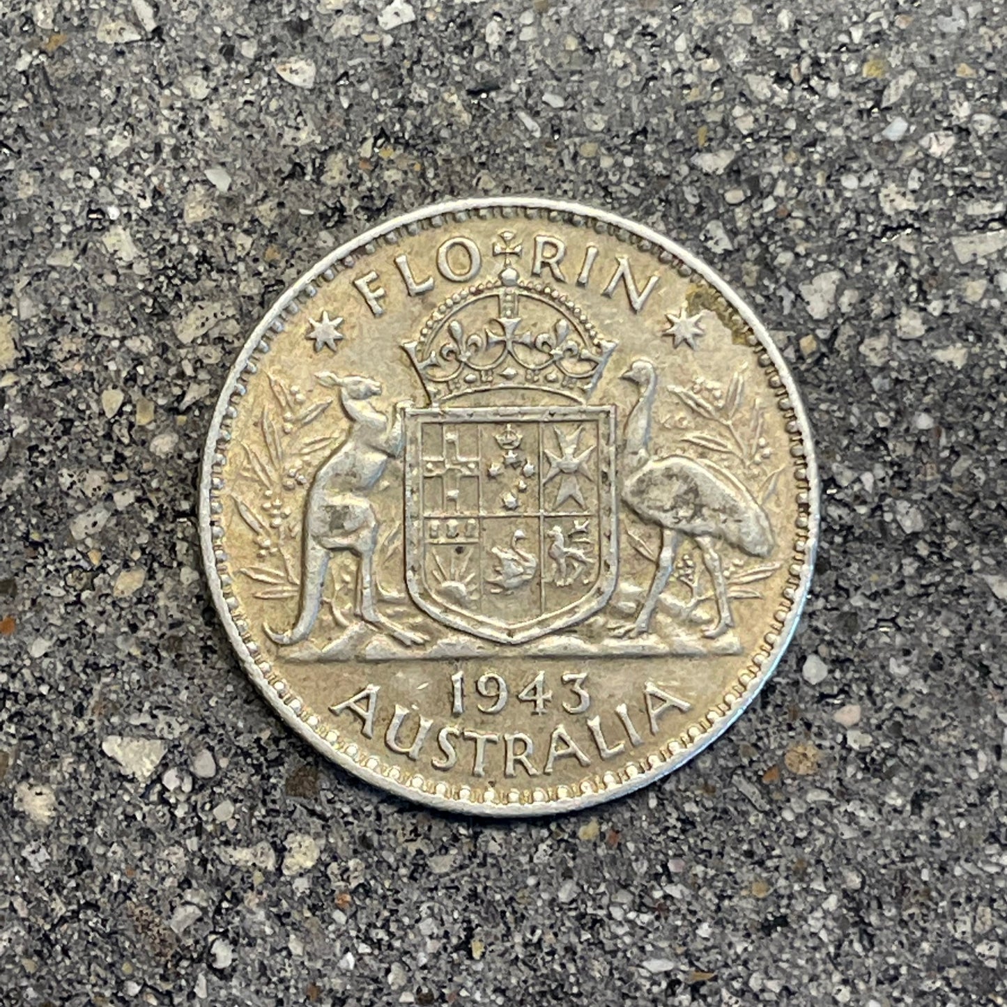 Australia Silver Florin back of coin on a concrete background.