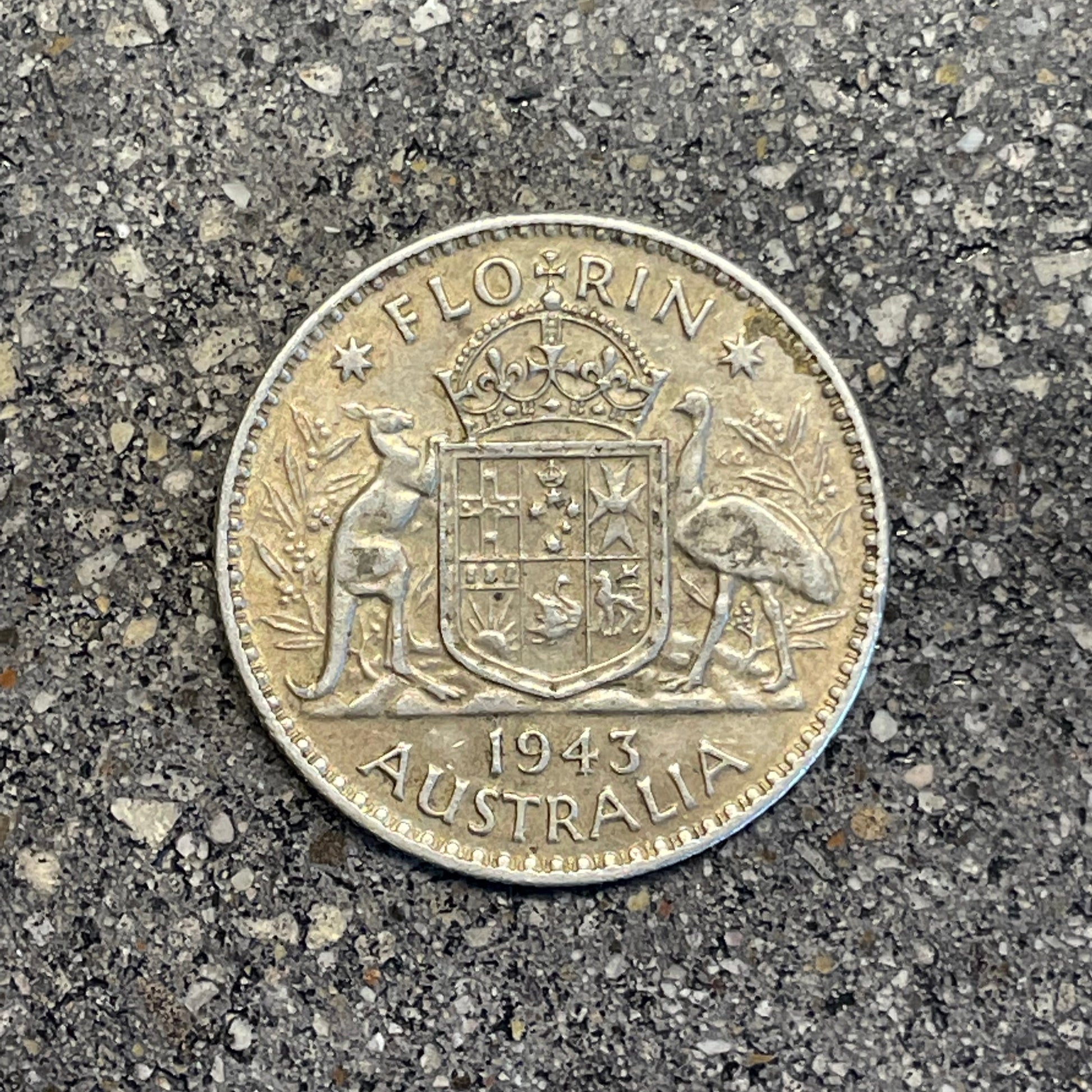 Australia Silver Florin back of coin on a concrete background.