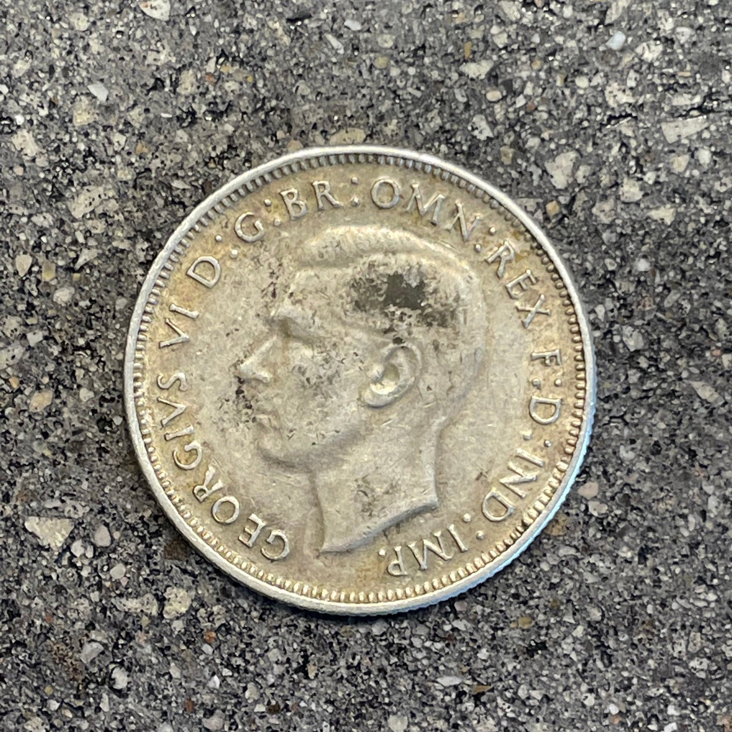 Australia Silver Florin front of coin on a concrete background.