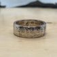 A Nation of Immigrants Half Dollar Coin Ring on wood round.