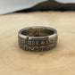 UK Half Crown Silver Coin Ring (1927-1936, G.B.) on a light wood round with mountain outline in background.