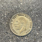 UK Half Crown Silver Coin front on a concrete background.