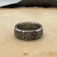 UK One Florin Silver Coin Ring on a light wood round.