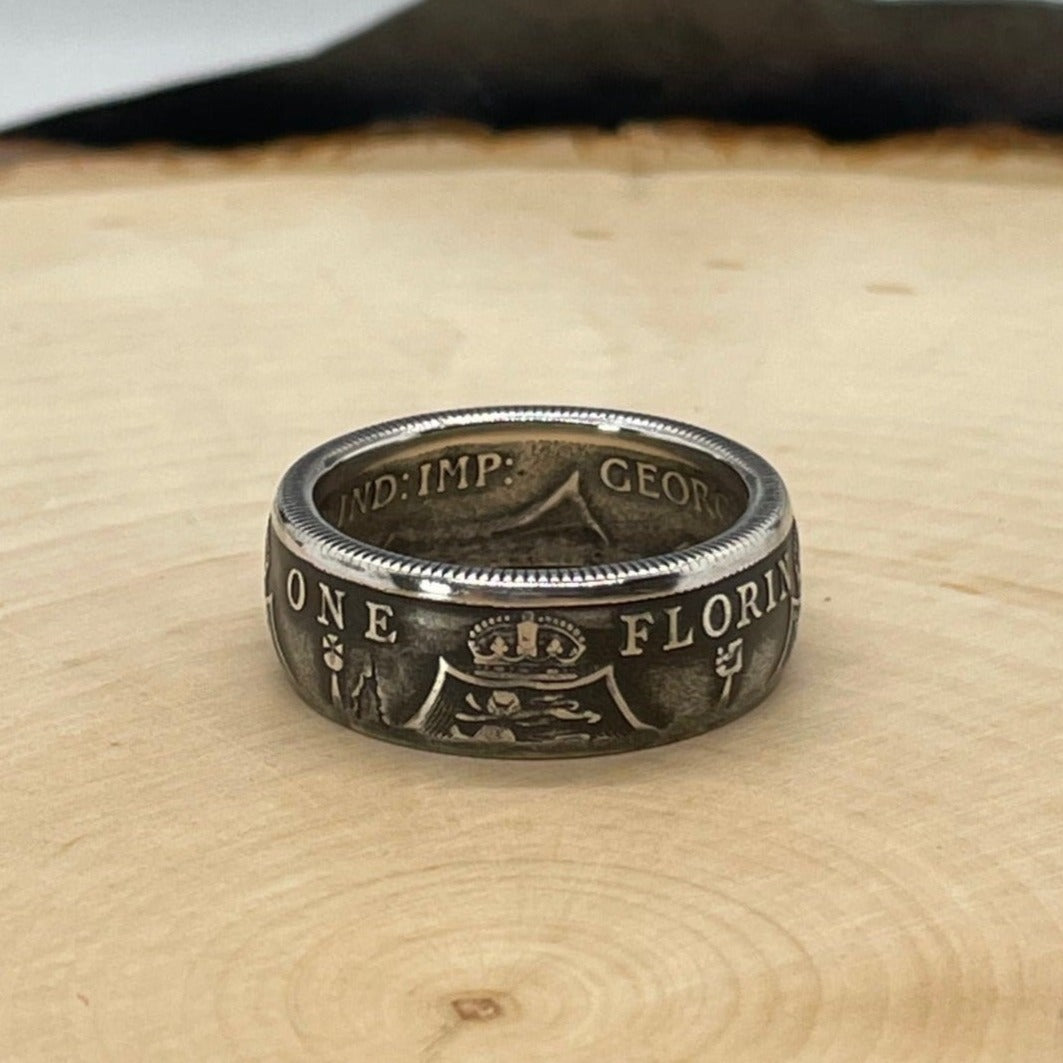 UK One Florin Silver Coin Ring on a light wood round.