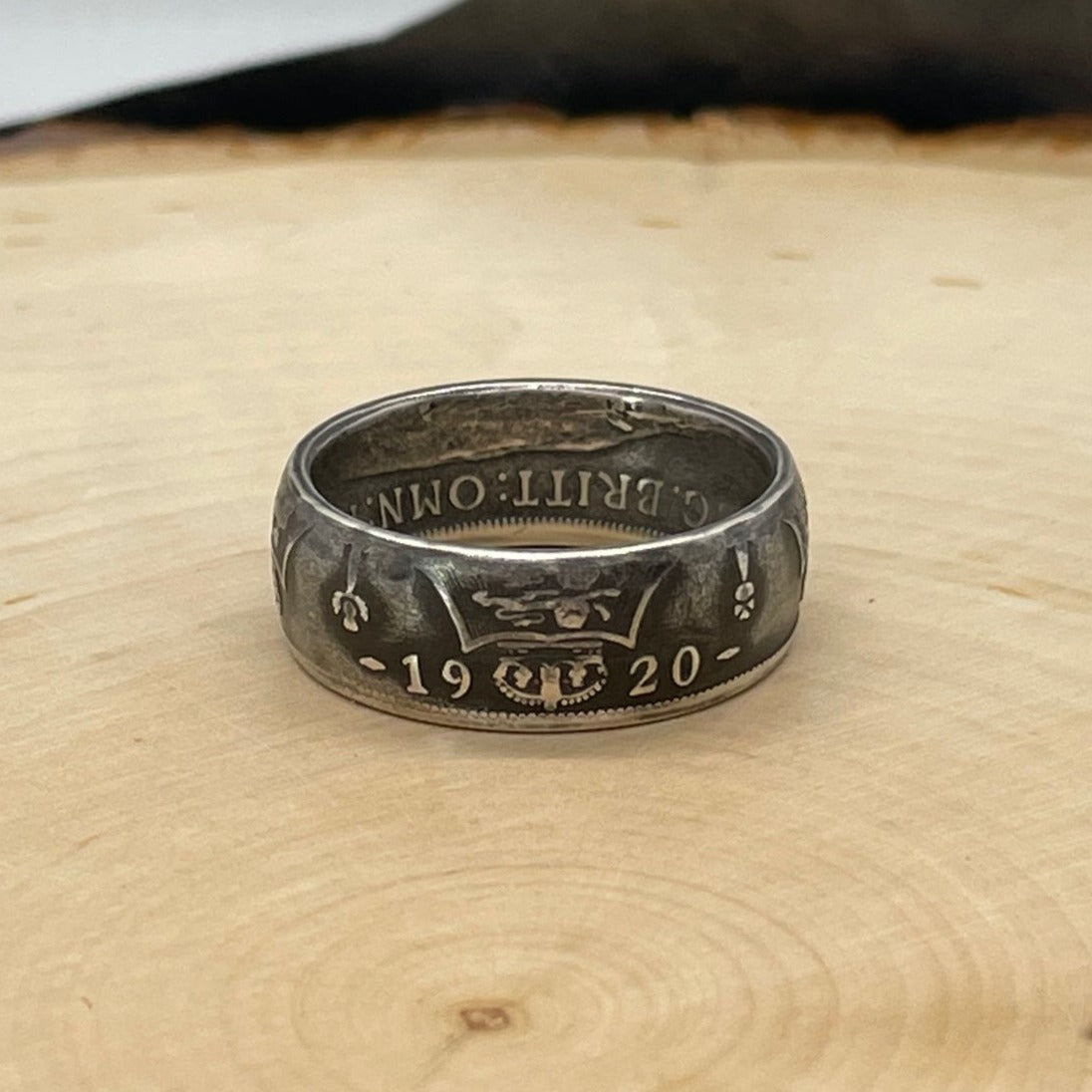 UK One Florin Silver Coin Ring on a light wood round.
