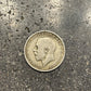 UK One Florin Silver Coin front on a concrete background.