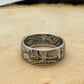 Walking Liberty Silver Half Dollar Coin Ring on a light wood round.